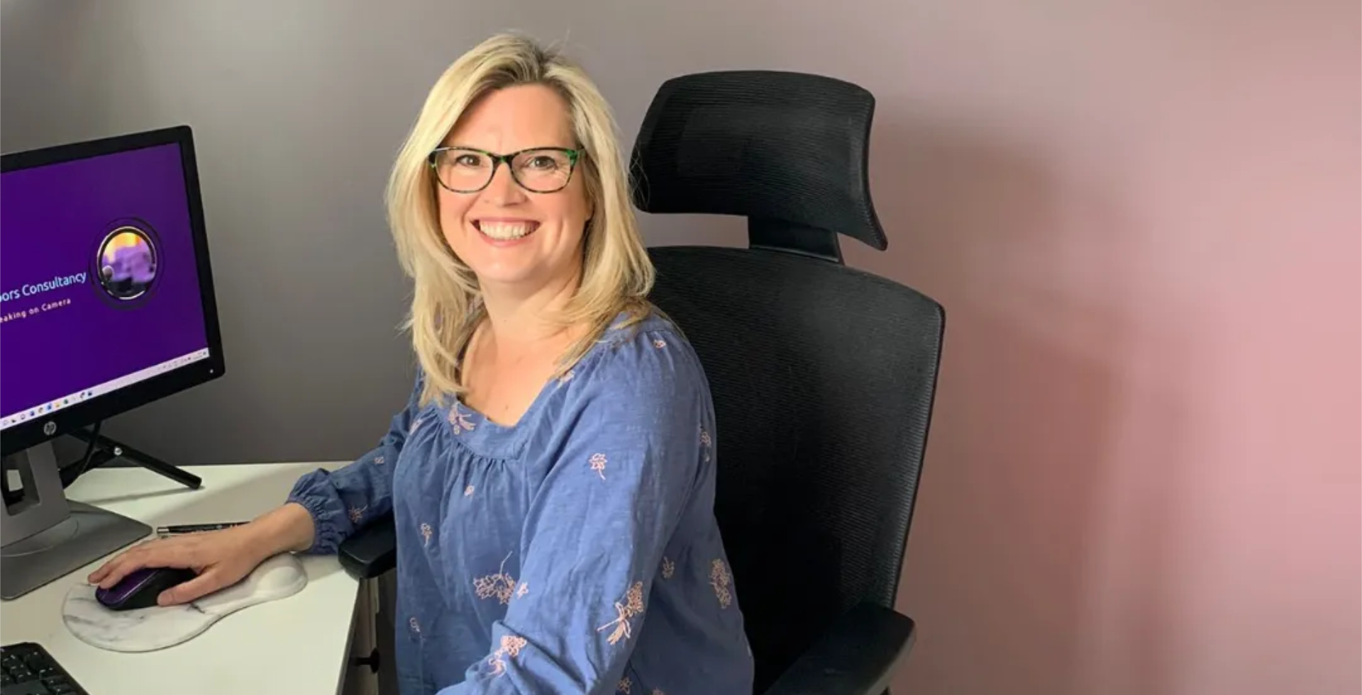 Kirsty van den Bulk sitting working at her desk
