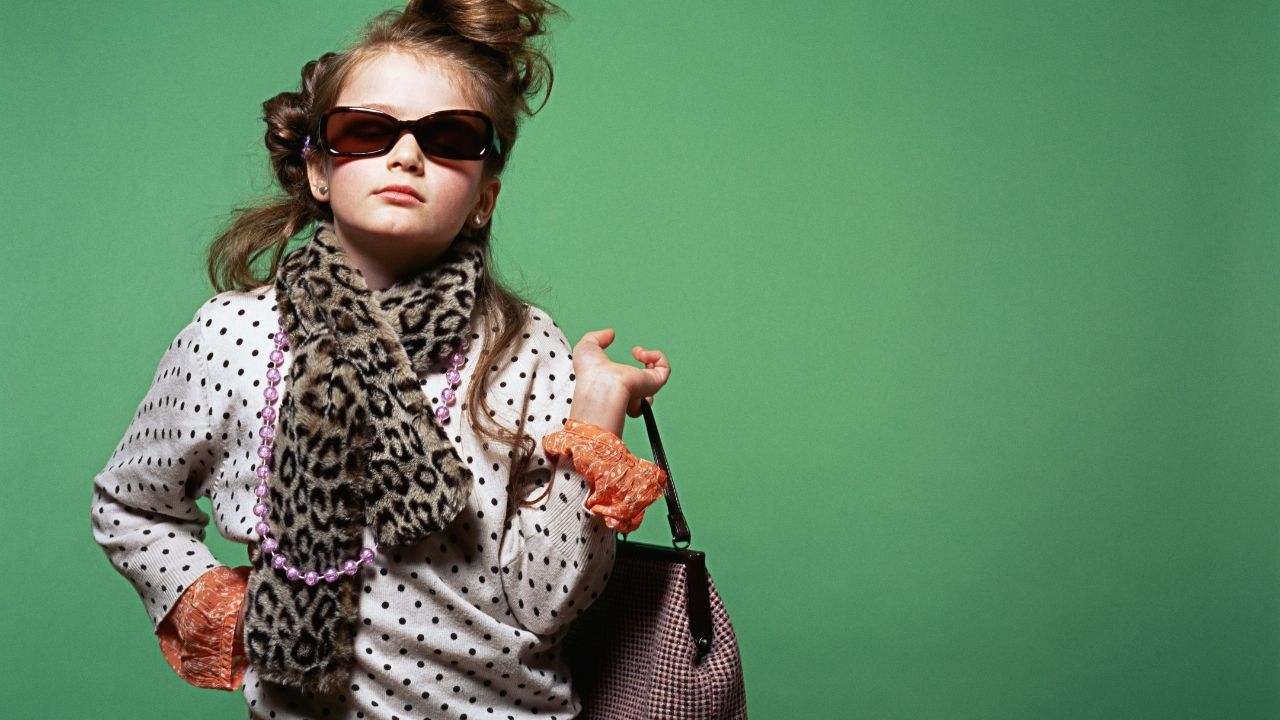 Dress for Success! A girl aged 8 dressed up in her Mum's clothes, holding a bag and wearing sunglasses